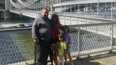 Bartlomiej Kuczynski, 45, a woman, 12-year-old-Jasmin Kuczynska, and Natasha Kuczynska, aged nine, near a river bridge