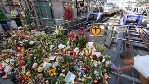 A makeshift memorial for an eight-year-old boy who died when a man pushed him and his mother in front of a train