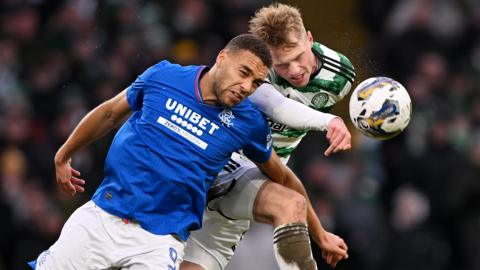 Celtic and Rangers players challenge for a header