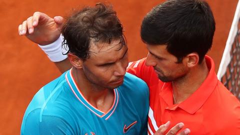 Rafael Nadal and Novak Djokovic hug after a match at the 2019 Italian Open