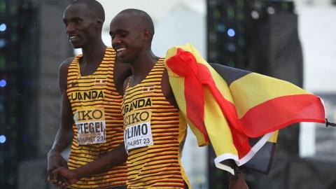 Jacob Kiplimo (right) and Joshua Cheptegei (left) of Team Uganda celebrate after respectively finishing first and third in the men's senior race during the 2023 World Cross Country Championships at Mount Panorama on February 18, 2023 in Bathurst, Australia.