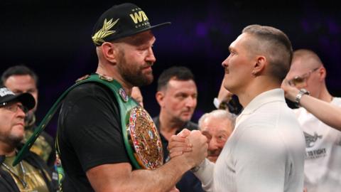 Tyson Fury and Oleksandr Usyk shake hands as they face off