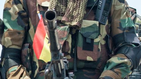 A photo of an unidentified Ghanaian soldier with a gun