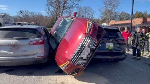 Car wedged between two other cars