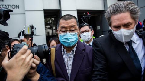 Hong Kong media tycoon and founder of Apple Daily newspaper Jimmy Lai (C) leaves the Kowloon City police station in Hong Kong on February 28, 2020,