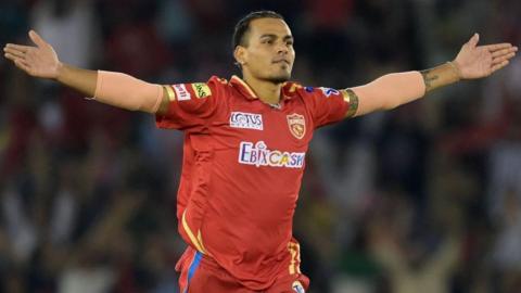 Rahul Chahar celebrates taking a wicket for Punjab Kings in the Indian Premier League, rising his arms outwards either side