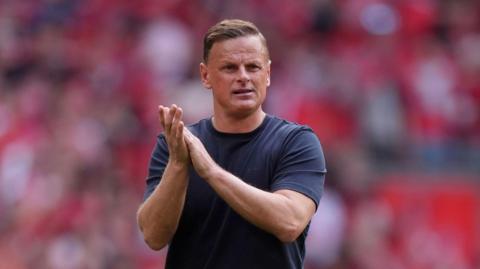 Richie Wellens applauds fans at the end of the League One play-off final