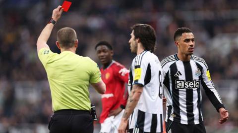 Jacob Ramsey of Newcastle United is shown a red card by referee Peter Bankes during the Premier League match against Manchester United