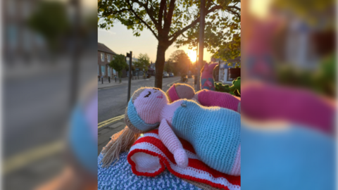 A knitted woman sunbathing 