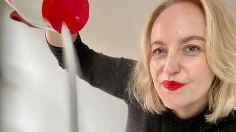 Lauren Potts (writer) pouring salt in front of her