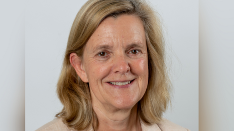 A headshot of Tandridge District Council leader Catherine Sayer, who has shoulder length fair hair and is wearing a beige jacket. She is only visible from the shoulders up. 