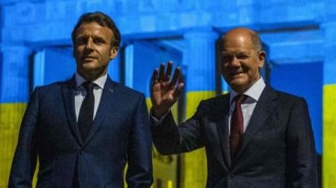 Macron and Scholz in front of Berlin's Brandenburg gate lit in Ukrainian colours