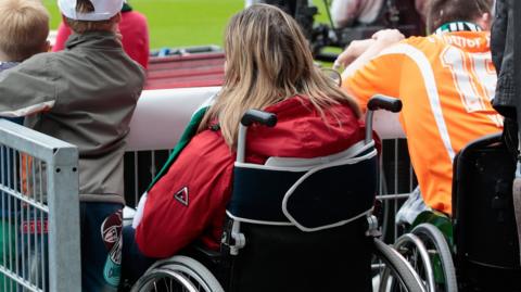 A disabled fan in a wheelchair watches a game in Germany 