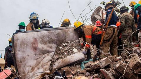 Firefighters remove debris in search of survivors in Les Cayes, Haiti on 17 August 2021