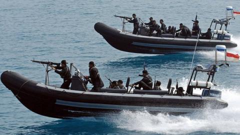 Indonesian marines sail armed speed boats during a simulation of the interception of a pirate ship - part of joint exercises with US navy seals off Sepa island, northern Jakarta, 27 July 2006.