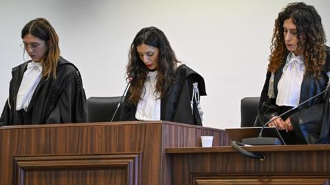 President of the court judge Brigida Cavasino, center, flanked by judges Claudia Caputo, left, and Germana Radice