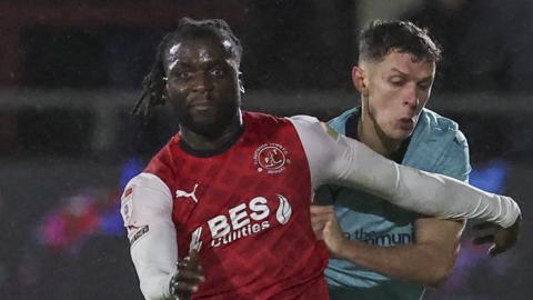 Fleetwood Town's Junior Quitirna shields the ball from Bolton Wanderers' Eoin Toal during the League One match at Highbury Stadium on December 29, 2023