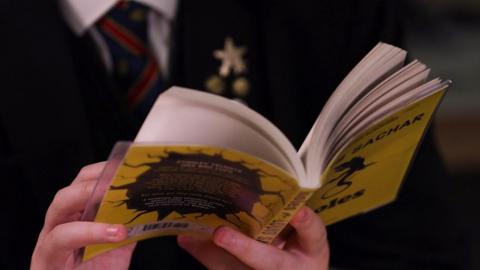 Pupil reading a book