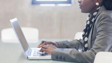 Woman typing on a laptop