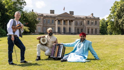 Musicians sitting in front of Ragley Hall