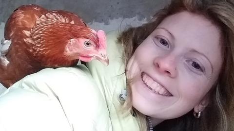 Lisa Thomas with a friendly hen