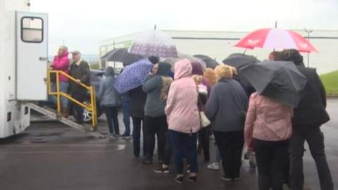 People queuing for TB screening session in Llwynhendy