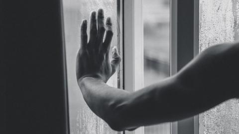 Hand on a window