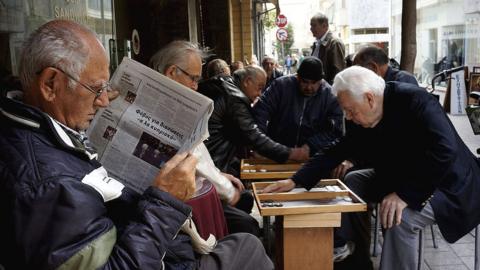 A man reads the morning newspaper on March 26, 2013 in Nicosia, Cyprus