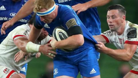 Leinster's James Tracy is tackled by two Ulster players