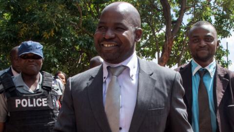 Zimbabwe's chief prosecutor Johannes Tomana (C) arrives at the Harare Magistrates court on February 2, 2016