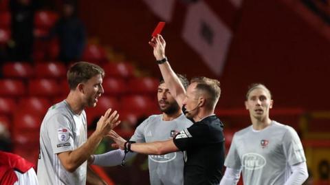 Exeter's Will Aimson is shown red against Charlton.