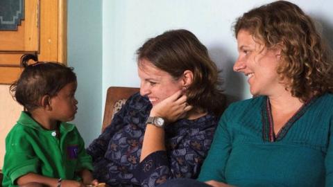 Dr Cat Morris and Dr Mary Cusack with a child they are helping