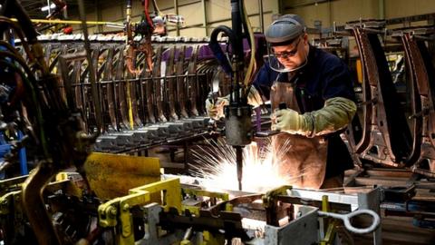 Two workers weld vehicle panels in Nissan's Sunderland factory in north east England, 12 Nov 2014