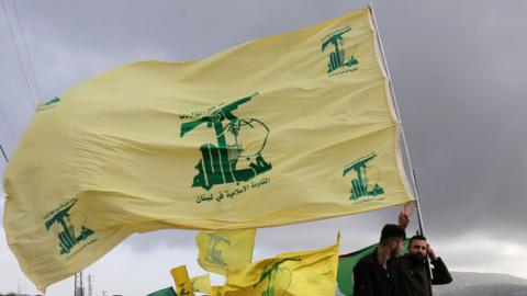 Hezbollah supporters fly the group's flag in Lebanon