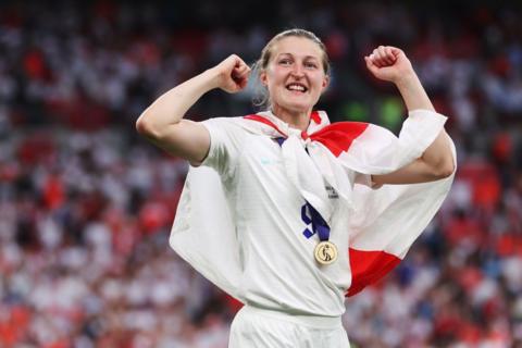 Ellen White seen with England flag around her shoulders and a medal round her neck after 2022 Euros final 
