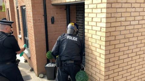 Police officers raid on a house