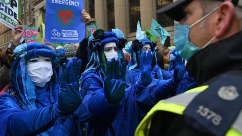 Police and protestors at COP26