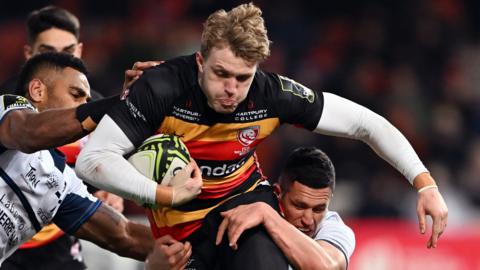 Ollie Thorley of Gloucester Rugby is tackled by Adrien Seguret and Andrea Cocagi of Castres