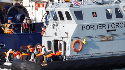 A Border Force boat carrying migrants arrives at Dover harbour