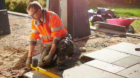 A man laying a patio