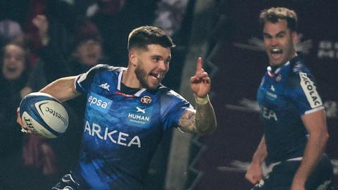 Matthieu Jalibert points with his index finger in celebration as he scores a try for Bordeaux Begles