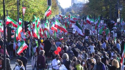Thousands of people marching with Iranian flags in Berlin