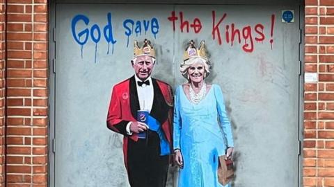 Graffiti portrait of King Charles and Queen Camilla