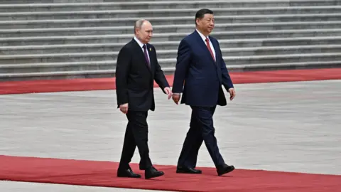 Russian President Vladimir Putin and Chinese President Xi Jinping attend an official welcoming ceremony in Beijing, China