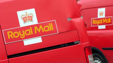 Two red Royal Mail vans
