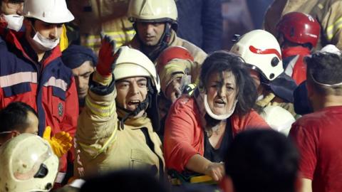A woman is rescued from the ruins of the building in Istanbul, 6 February