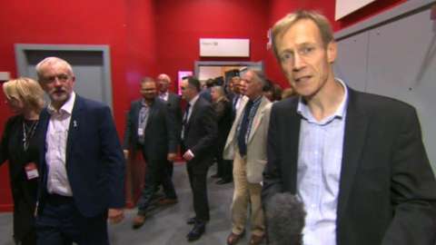 David Cornock reporting, watched by Jeremy Corbyn