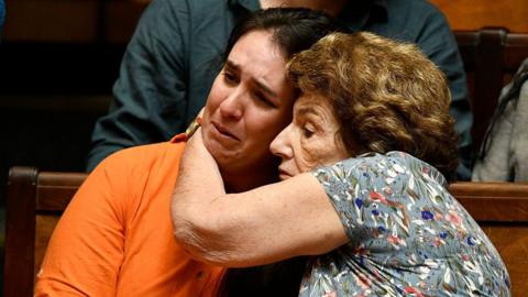 Florencia Salgueiro, left, a leading advocate for assisted dying in Uruguay, is comforted as senators debate a euthanasia bill at the Legislative Palace in Montevideo, on 15 October 2025.