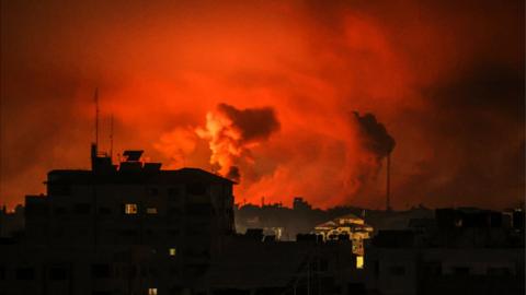 Smoke billowing on an orange sky in Gaza