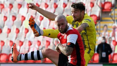 Fylde's Jordan Lussey challenges Nicky Law of Exeter